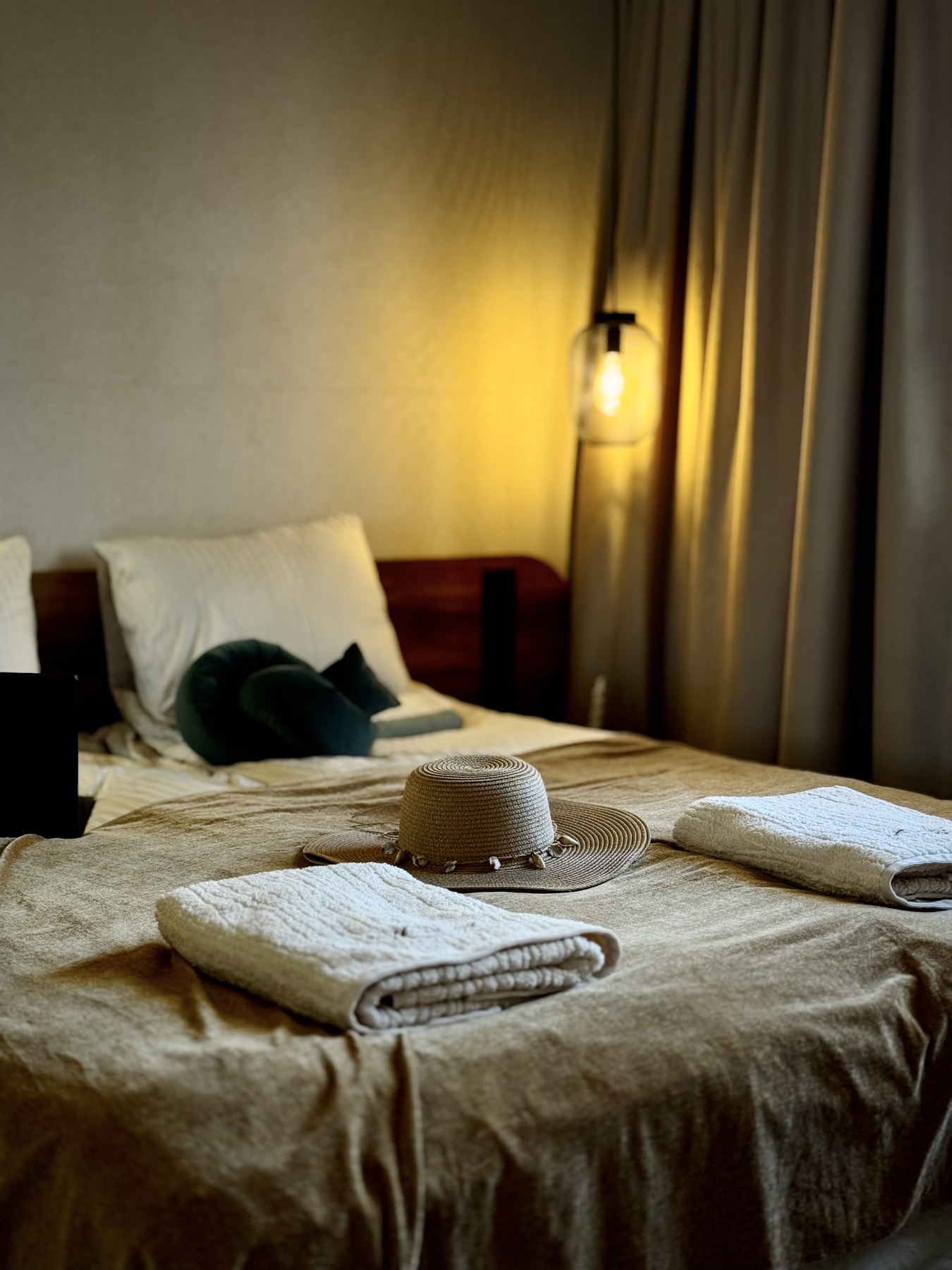 A sun hat resting on the bed