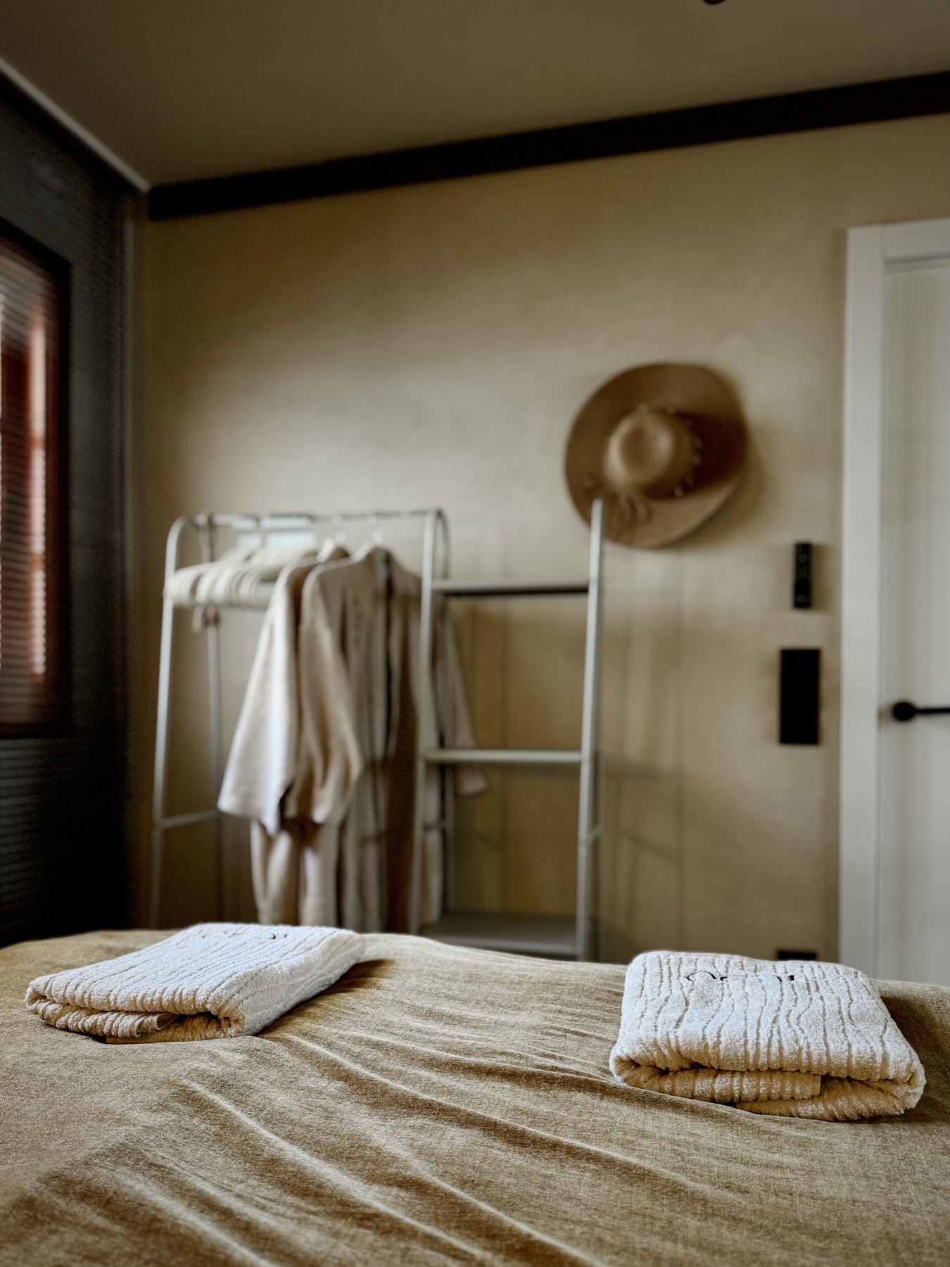 Soft cotton robes on a rail in the bedroom